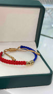 PULSERA TEJIDA AZUL Y ROJO